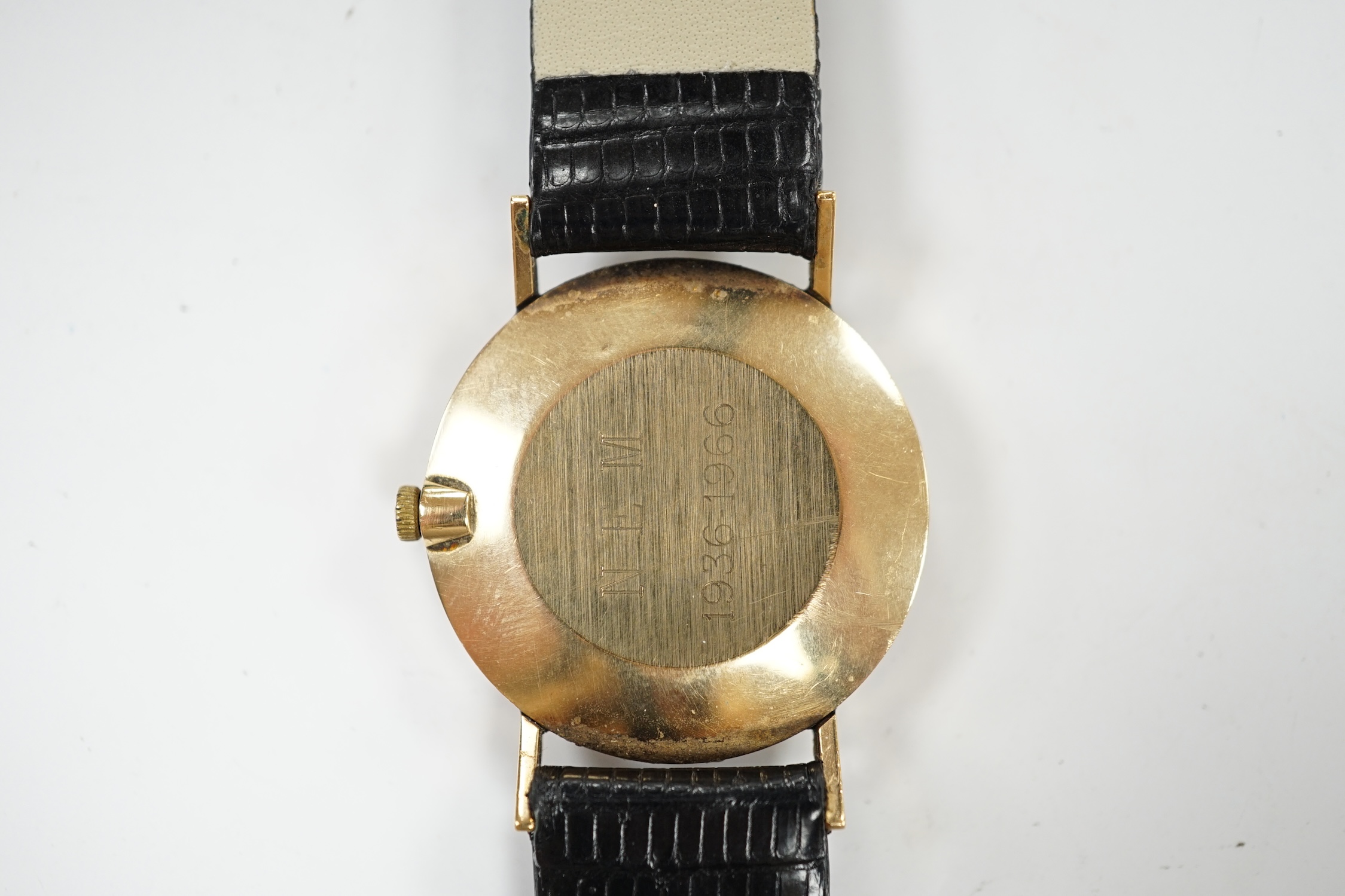 A gentleman's 9ct gold Longines manual wind wrist watch, with case back inscription, on associated leather strap. Condition - poor